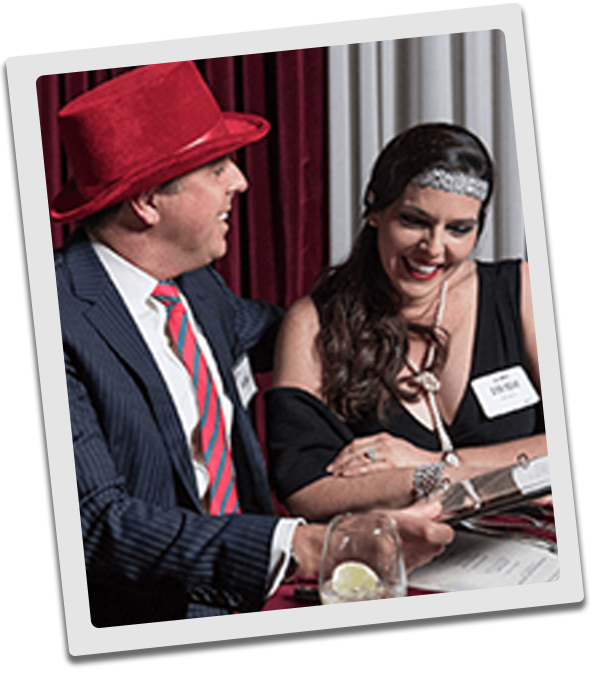Grand Rapids Murder Mystery couple checking out the dinner menu